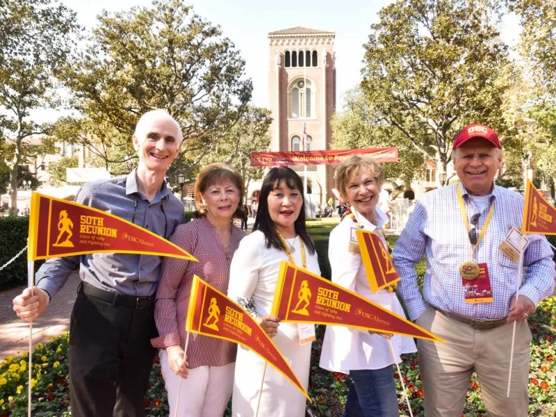 alumni attend their 50-year reunion holding USC pennants