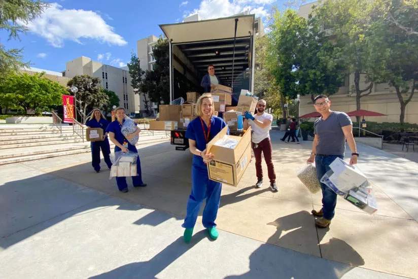 USC doctor Kenji Inaba, right, and other health care workers unpack protective medical supplies donated from the set of ABC’s Grey’s Anatomy. (Photo/Kimberly Shemanski)