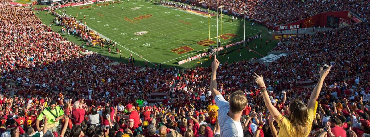 crowd of football fans in the stands at the LA Coliseum