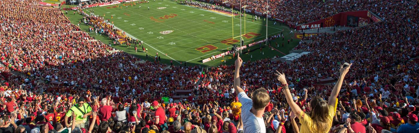 crowd of football fans in the stands at the LA Coliseum