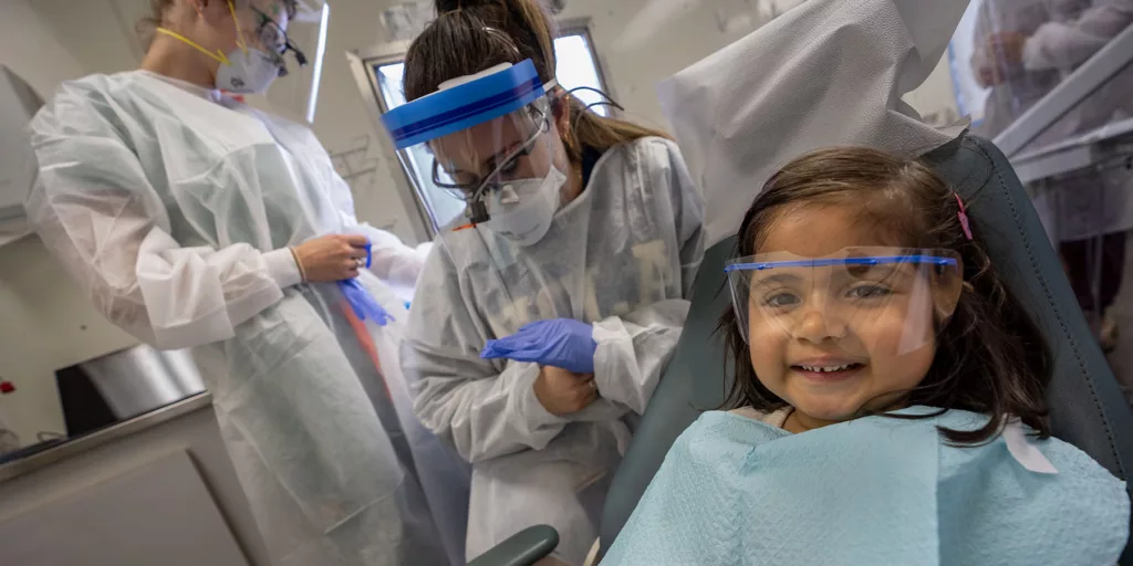 A 4-year-old gets her first check-up from dental students at Herman Ostrow School of Dentistry of USC in the school’s mobile dental clinic.