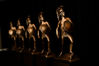 Alumni Awards Header, Tommy Statues