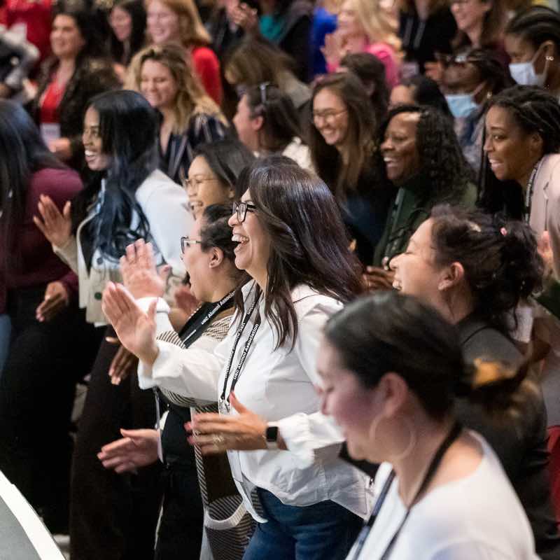 crowd of women laughing in an auditorium