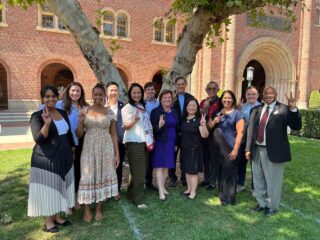 group photo on the lawn in front of Bovard Administration Building