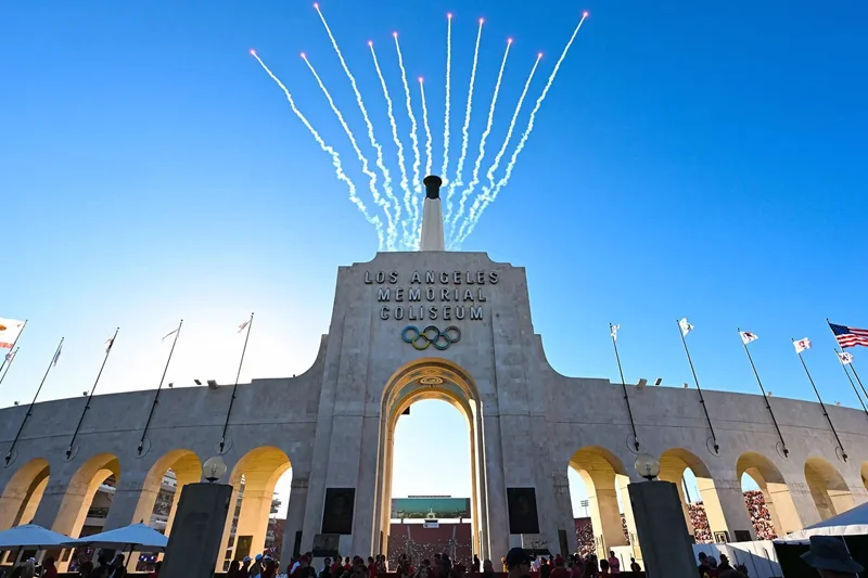 the facade of LA Memorial Coliseum with the Olympics logo