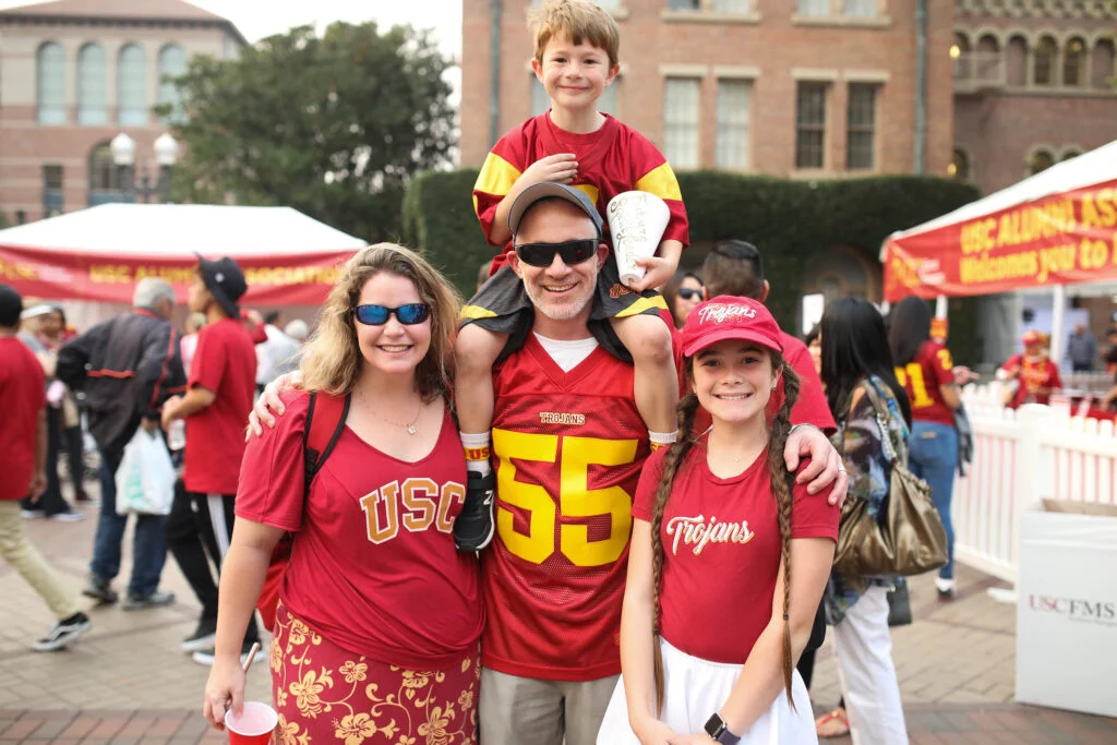 a family of four with two children at a USC alumni events