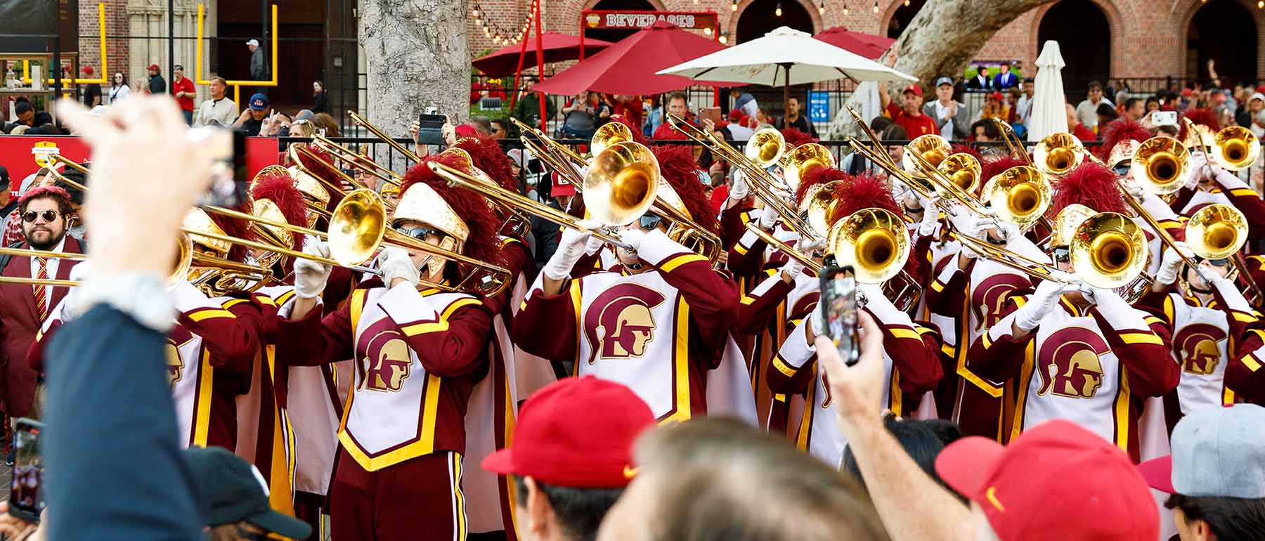 trombonists lift their instruments during a performance